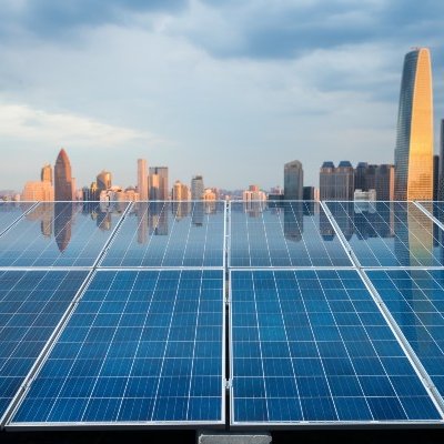 Solar panels with cityscape in the background. 